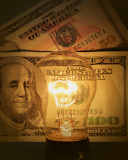 Light bulb with money in background