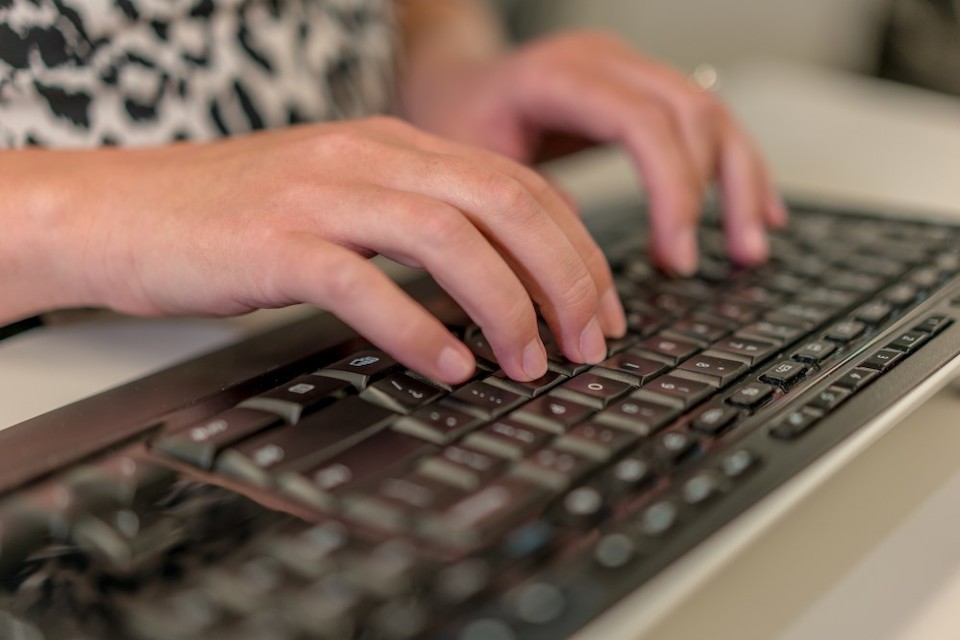 QuickBooks online; woman typing on computer keyboard