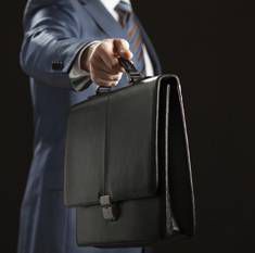 man handing briefcase