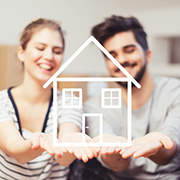 Male and female couple holding out their hands with a simple cartoon drawing of a house sitting in their palms