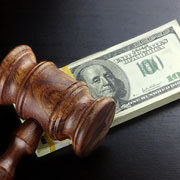 Gavel resting on a stack of $100 bills