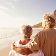 Senior couple standing on a beach in the morning